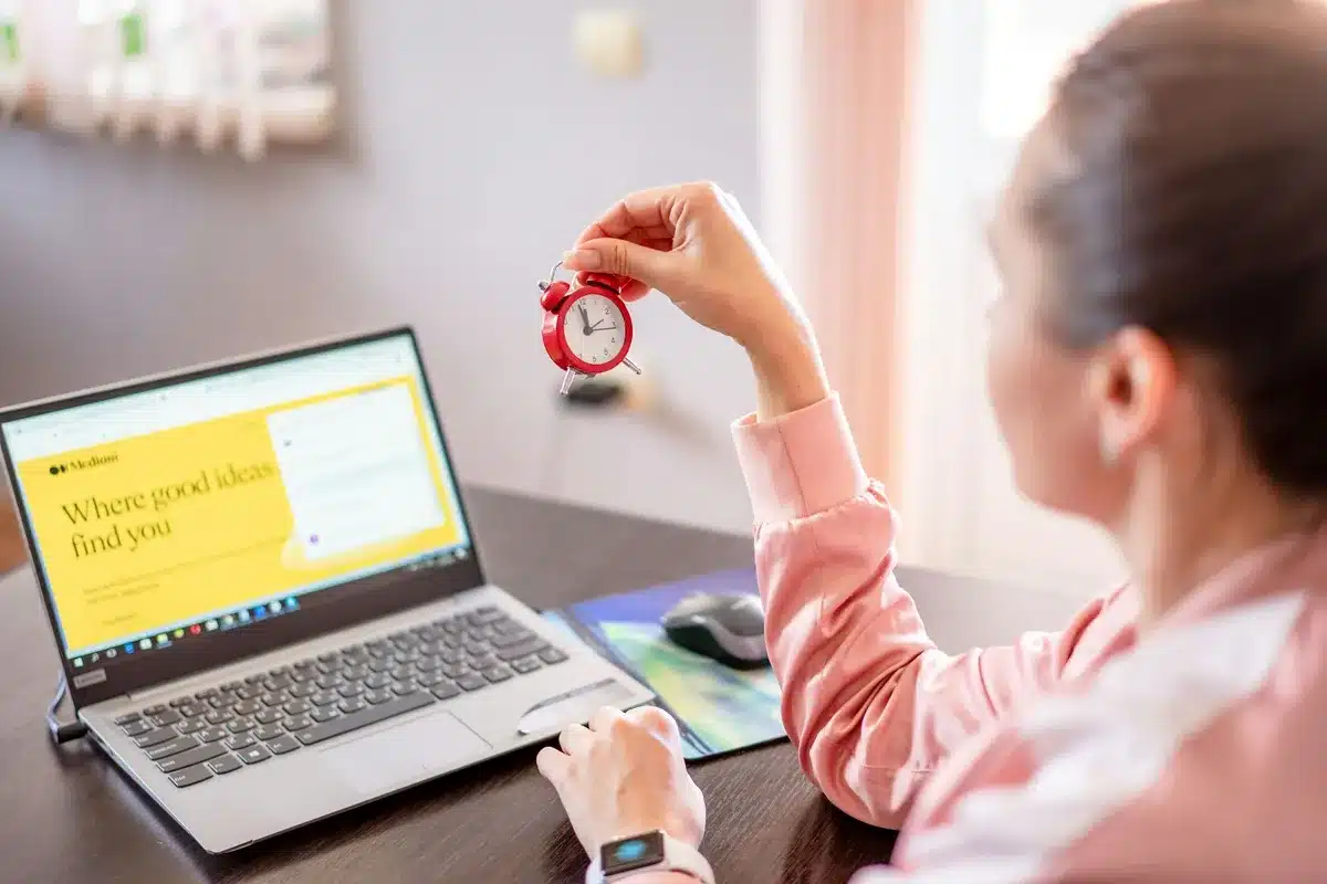 Woman looking at red clock in her hand