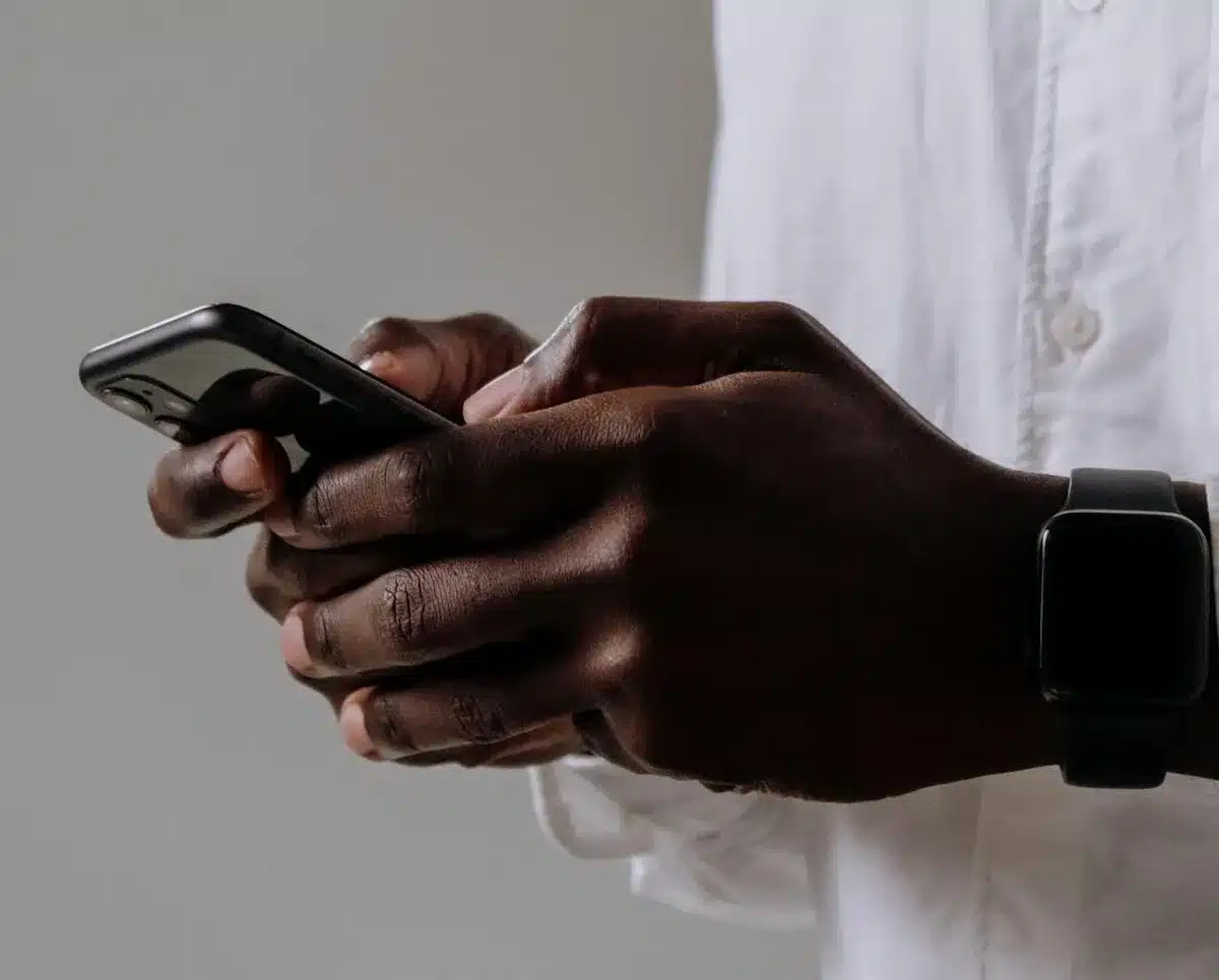 Person holding phone while looking at non mobile-friendly website
