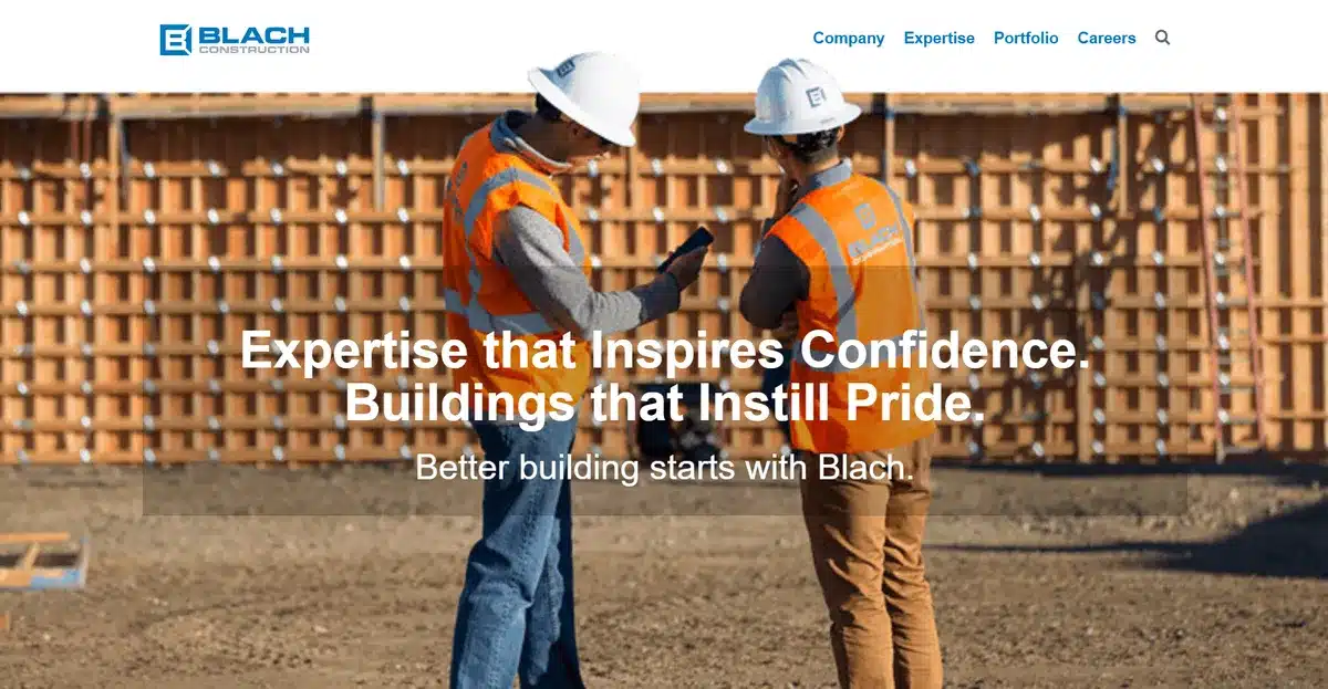 Blach Construction website showing 2 employees discussing a construction project