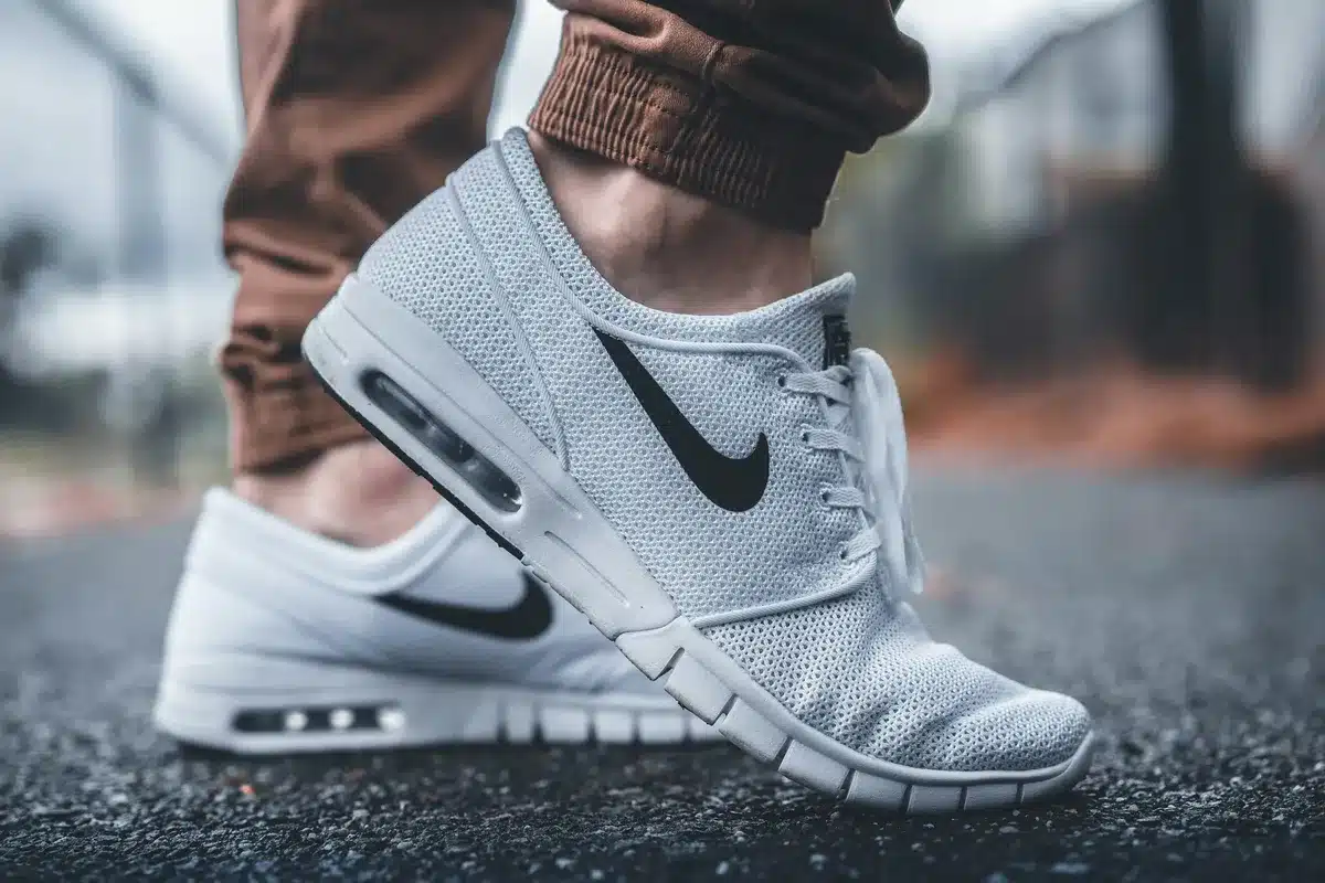 White nike sneakers with a black nike swoosh logo
