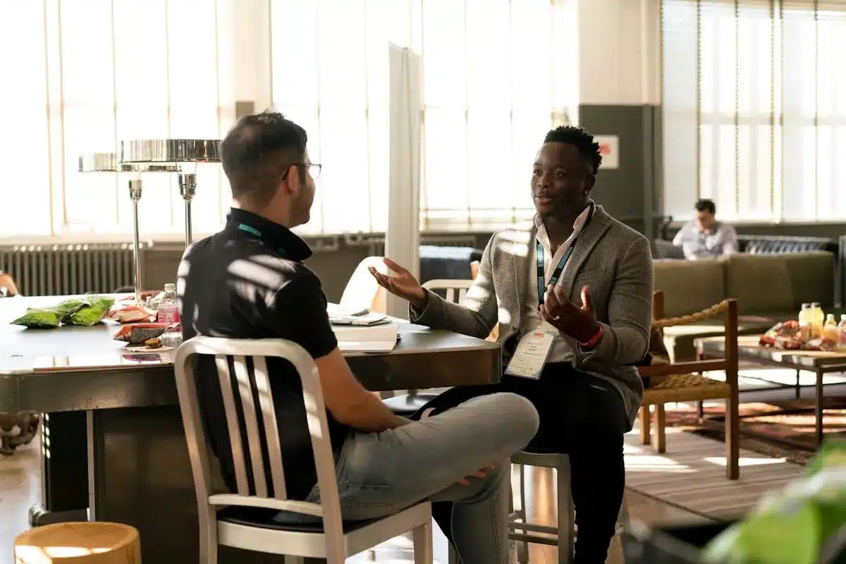 meeting between two people talking about their rebranding checklist