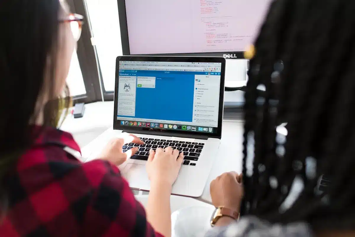 Two people working on a website