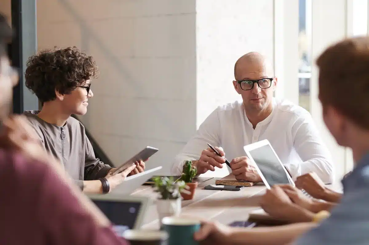 Coworkers in a meeting talking about their brand new brand identity guidelines