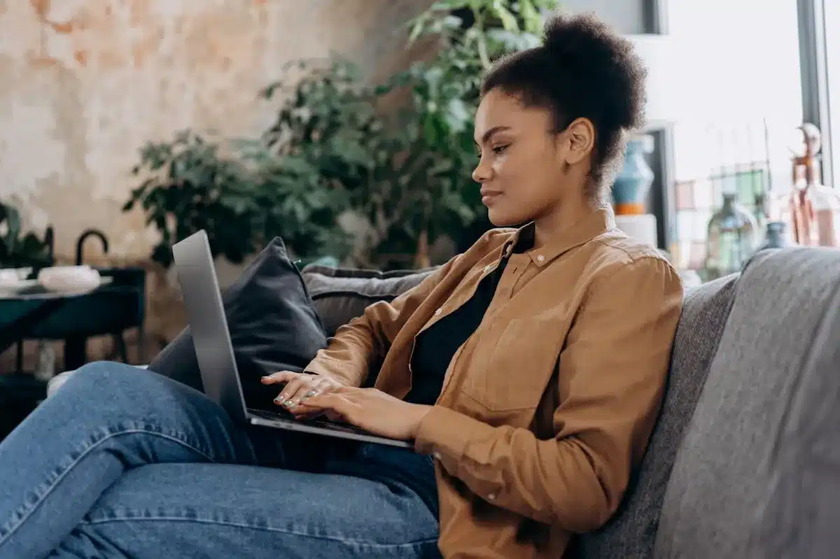 Woman using laptop while sitting on a couch